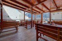 a large room with wooden benches in a building at Hotel Galia in Kotor