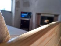 a close up of a wooden bench in a room with a fireplace at Casa Cueva “La Estrella” in Granada