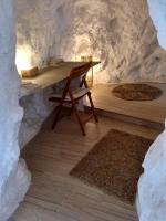 a table in a cave with a stone wall at Casa Cueva “La Estrella” in Granada