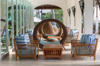 a group of chairs and tables on a patio at Katathani Phuket Beach Resort - SHA Extra Plus in Kata Beach