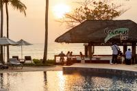 a group of people standing around a pool at a resort at Katathani Phuket Beach Resort - SHA Extra Plus in Kata Beach