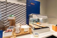 a display case with donuts and other pastries at Holiday Inn Express Hotel & Suites San Dimas by IHG in San Dimas