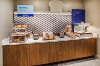 a bakery with a counter with donuts on it at Holiday Inn Express Hotel & Suites San Dimas by IHG in San Dimas