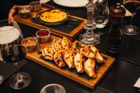 a plate of food on a table with a pizza at Algodon Wine Estates & Champions Club in San Rafael