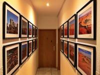 a hallway with a bunch of pictures on the wall at Landlust Hotel in Gransee