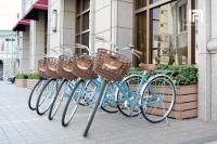 a row of bikes parked in front of a building at Fushin Hotel Taichung in Taichung