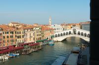 a view of a river with a bridge and buildings at Palazzo Bembo - Exclusive Accommodation in Venice
