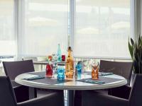 una mesa con una botella y vasos. en ibis Styles Marseille Aéroport, en Vitrolles