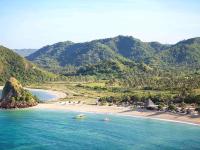 two boats in the water next to a beach at Novotel Lombok Resort & Villas in Kuta Lombok