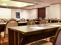 a conference room with tables and chairs with wine glasses at Novotel Lombok Resort & Villas in Kuta Lombok