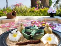 a tray topped with bowls and flowers on a table at Novotel Lombok Resort & Villas in Kuta Lombok