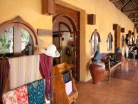 a room with a couch and a hat on the wall at Novotel Lombok Resort & Villas in Kuta Lombok