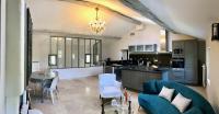 a kitchen and living room with a couch and a table at La Bri...Gite in L&#39;Isle-sur-la-Sorgue