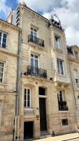 an old building with two balconies on top of it at La Course in Bordeaux