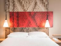 a bedroom with a white bed and two lights at ibis Paris Bastille Faubourg St Antoine in Paris