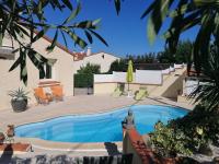 a swimming pool in the backyard of a house at La Picholine in Sorède