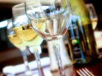 two glasses of white wine sitting on a table at Mercure Bunbury Sanctuary Golf Resort in Bunbury