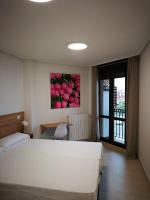 A bed or beds in a room at Apartamentos Gran Socaire de Noja