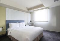 a bedroom with a large white bed and a window at Dandy Hotel-Daan Park Branch in Taipei