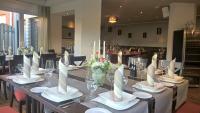 a table with plates and napkins on top at Hotel - Restaurant Veldscholten in Lingen