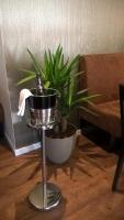 a plant in a pot sitting next to a table at Hotel - Restaurant Veldscholten in Lingen