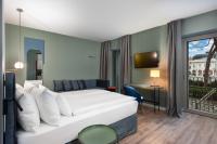 A bed or beds in a room at HT Hotel Trieste