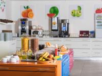 a kitchen with a counter with food on it at ibis Styles Nivelles in Nivelles