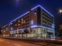a building with blue lights on the side of it at Novotel München City Arnulfpark in Munich
