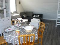 a living room with a table and a couch at Sauvagere, studio à Carnac in Carnac