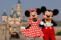 two mickeys dressed in costumes in front of a castle at Maison du Lavoir Disneyland in Bailly-Romainvilliers