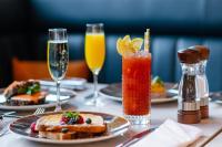 una mesa con platos de comida y copas de bebidas en Hotel Indigo Manchester - Victoria Station by IHG, en Mánchester