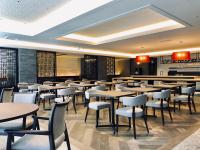 a restaurant with tables and chairs in a room at ART Hotel Oita in Oita