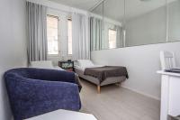a room with a couch and a bed and a mirror at Best Western Hotel Apollo in Oulu
