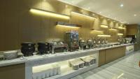 a restaurant with a counter with plates and appliances at Holiday Inn Express Shanghai Gongkang by IHG in Baoshan