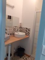 a bathroom with a sink and a mirror at Auberge des chemins in Moissac