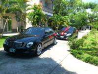 two cars parked on a street next to a building at Feng Lin Homestay in Shuili