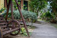a wooden bench sitting next to a walking path at Be my house in Magong