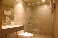 a bathroom with a shower and a toilet and a sink at The Cloud Hotel in Taichung