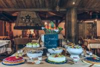 a table with cakes and bowls of food on it at Hôtel Le Sherpa Val Thorens in Val Thorens
