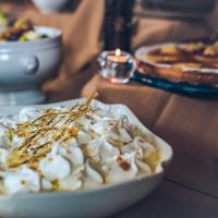 a white bowl of food on a table at Hôtel Le Sherpa Val Thorens in Val Thorens