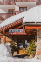 a hotel with snow on top of a building at Hôtel Le Sherpa Val Thorens in Val Thorens