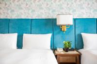 a bedroom with two beds and a blue wall at Jia Hsin Garden Hotel in Tainan