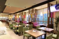 a restaurant with tables and chairs and a large window at Beitou Hot Spring Resort in Taipei