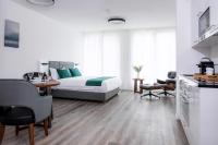 a bedroom with a bed and a table and chairs at K BUSINESS in Zuchwil