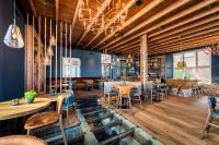 a restaurant with wooden ceilings and tables and chairs at Boutique Hotel De Beerze in Middelbeers