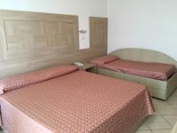 A bed or beds in a room at Hotel Excelsior