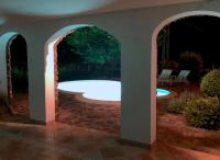 a swimming pool in a backyard with two archways at ALPHA in Badacsonytördemic