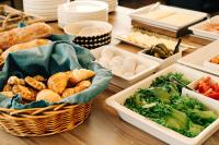 a table topped with trays of different types of food at Hotel Sparre in Porvoo