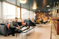 a man sitting on a couch in a living room at Hotel Sparre in Porvoo