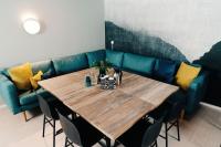 a table with a blue couch in a room at Hotel Sparre in Porvoo